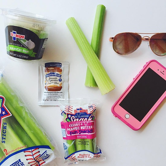 Dandy Celery and Peanut Butter Snack Pack sitting on a table with a phone and sun glasses