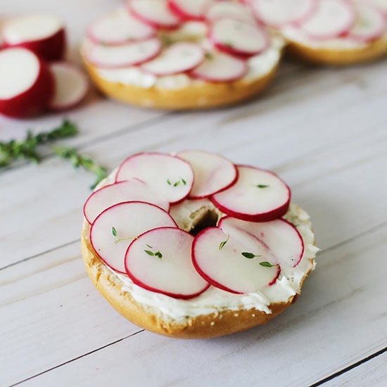 sliced Dandy Ready Radishes on top of a bagel